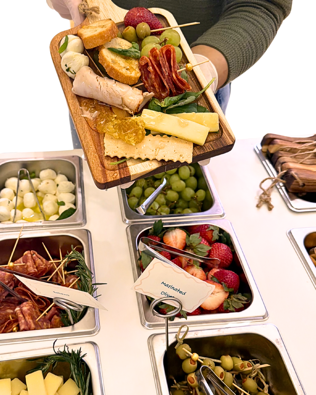 Styled charcuterie spread with artisan cheeses on the BiteHaus signature cart