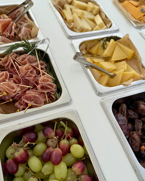 Guests gathering at the BiteHaus bottomless charcuterie cart