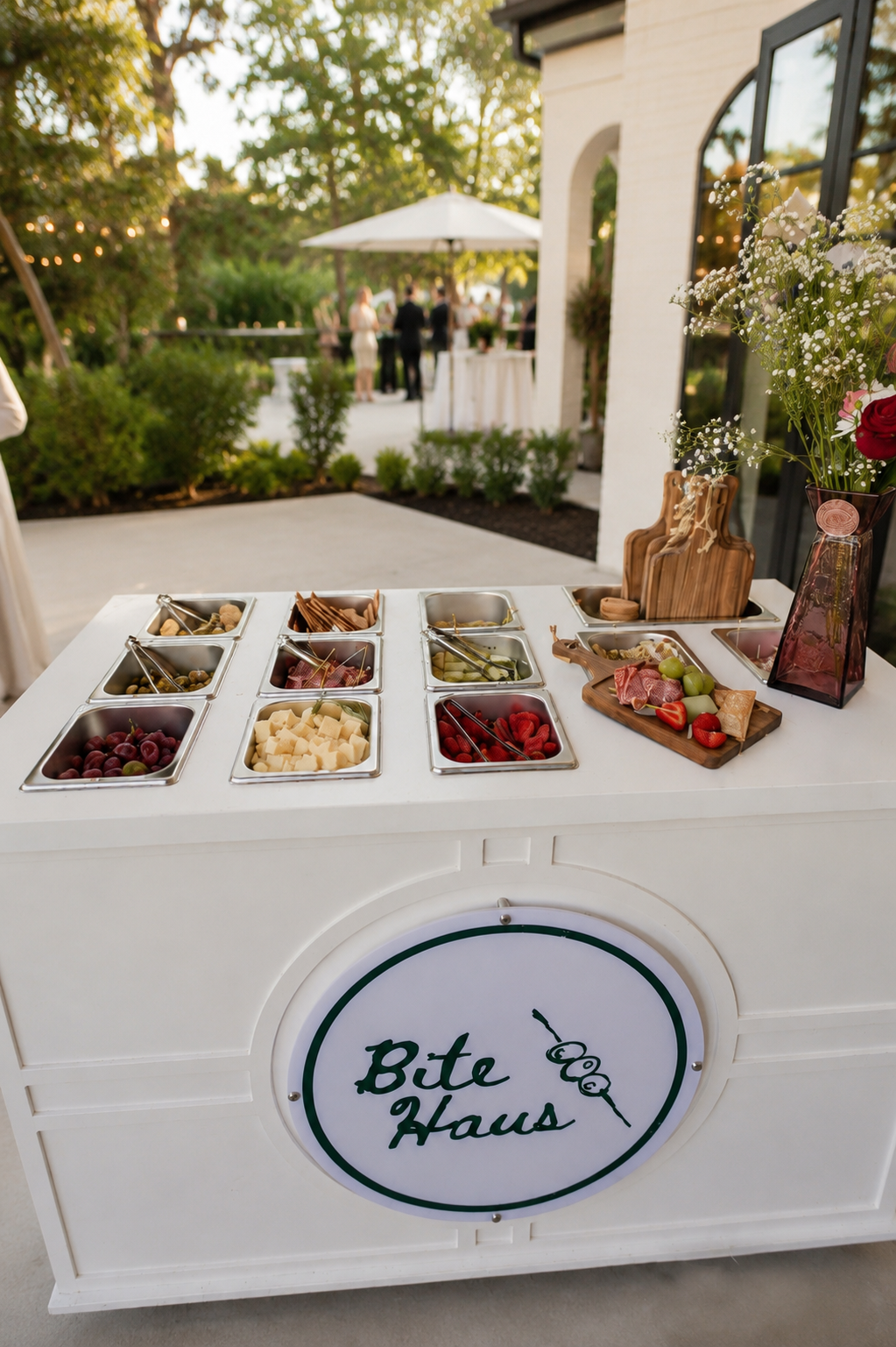 BiteHaus Signature Charcuterie Cart set up on a garden terrace before an event