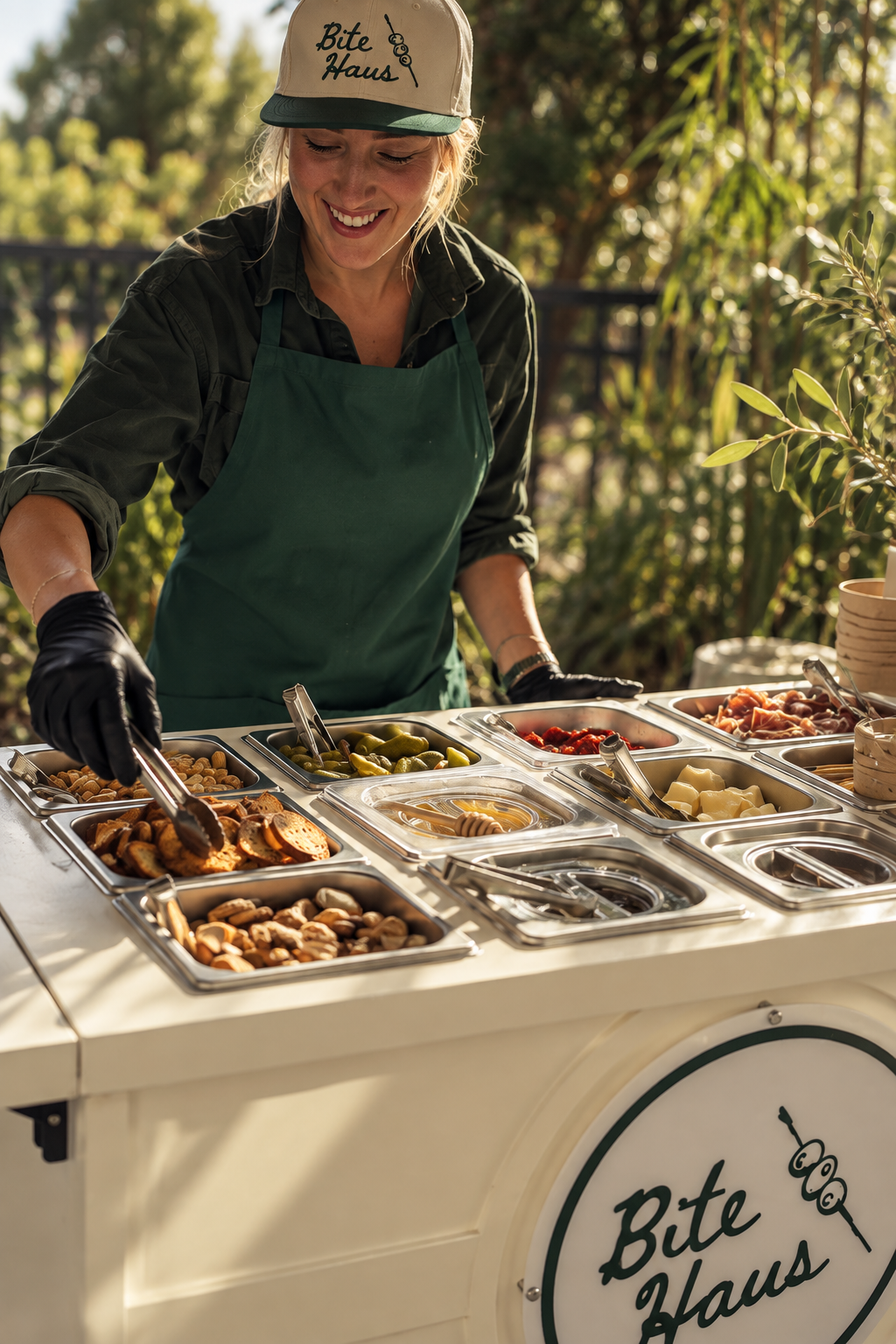 BiteHaus team member serving from the Signature Charcuterie Cart outdoors
